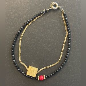 Layered Black and Gold Beaded Bracelet with Red Bead Accent